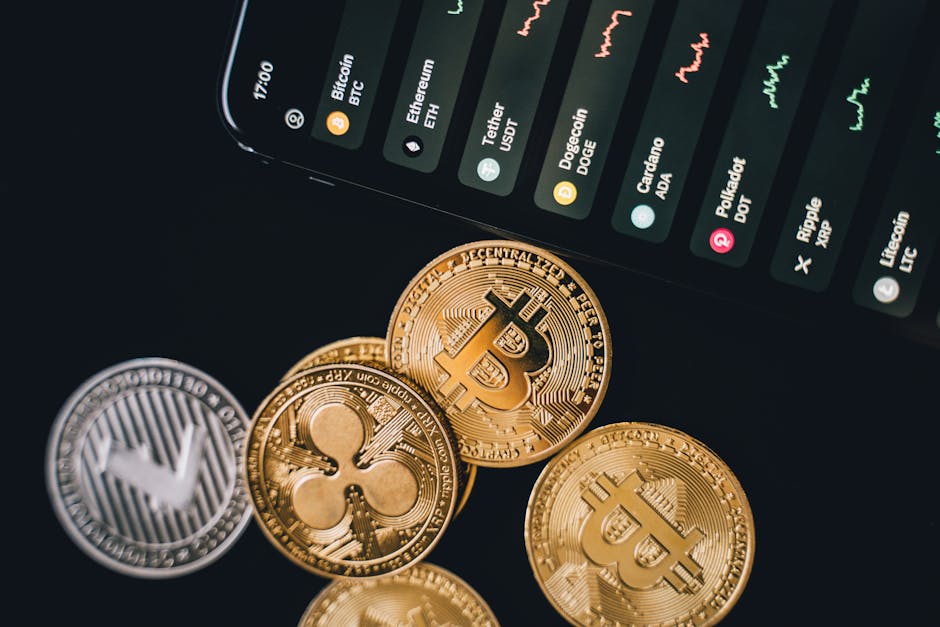 Close-up view of various cryptocurrency coins with a digital market display in the background.