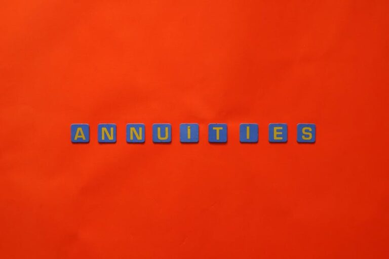 Conceptual image of the word 'Annuities' spelled with tiles on a vibrant red background.